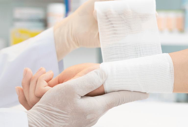 Doctor wrapping patients wrist