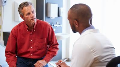 Male patient talking with male doctor