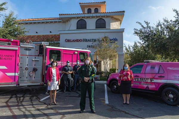 (L:R) Dr. Alka Arora, medical oncologist, Orlando Health UF Health Cancer Center, Chief Nancy Brown, Orange County Sheriff’s Office and Lindsay Jacques, director, Physician Practices, Orlando Health UF Health Cancer Center. Back row Orange County Fire Rescue.