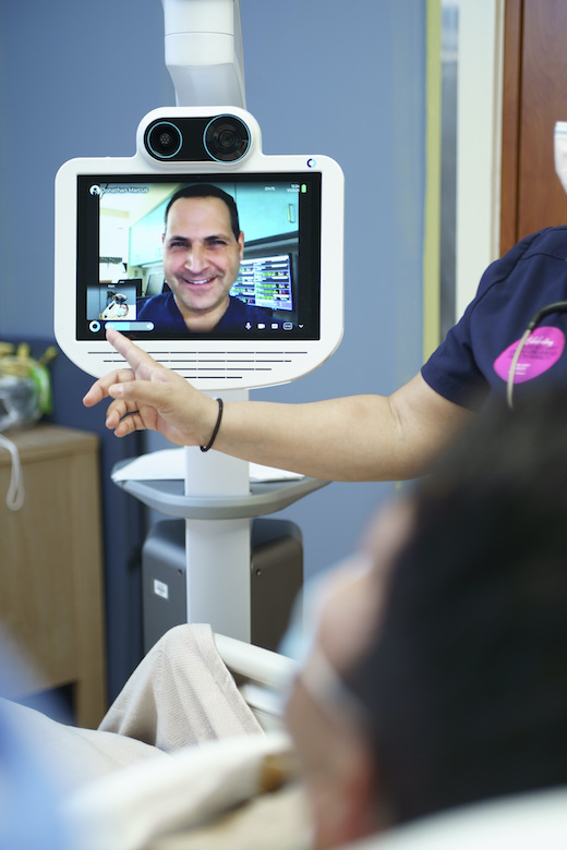 A critical care physician at a patient’s beside in the intensive care unit.