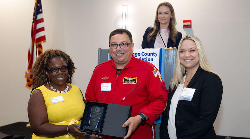 Peonca Grier, Miles Morgan, and Brittany Melendez. Grier and Melendez, Co-Chairs of the OCBA's Law Week Committee; Jill Davis, Esq., Corporate Counsel, Legal Affairs, Orlando Health, at podium