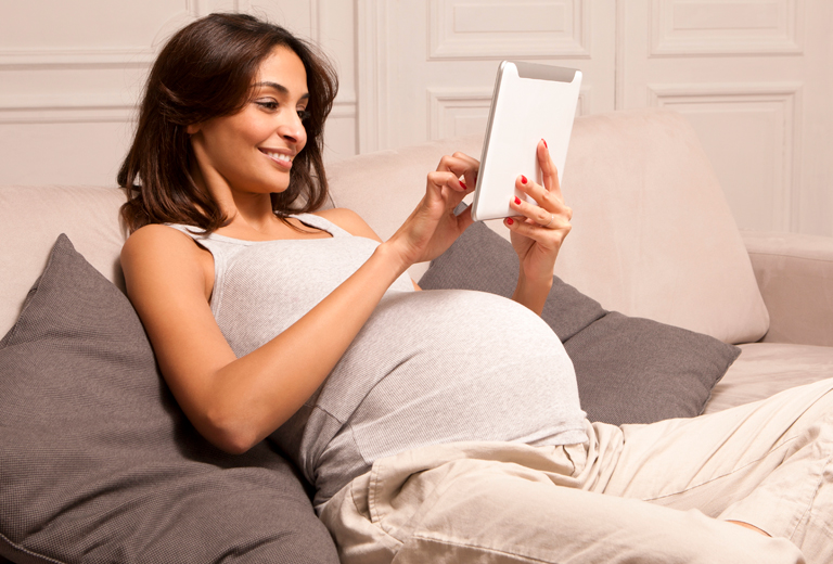 pregnant woman using tablet