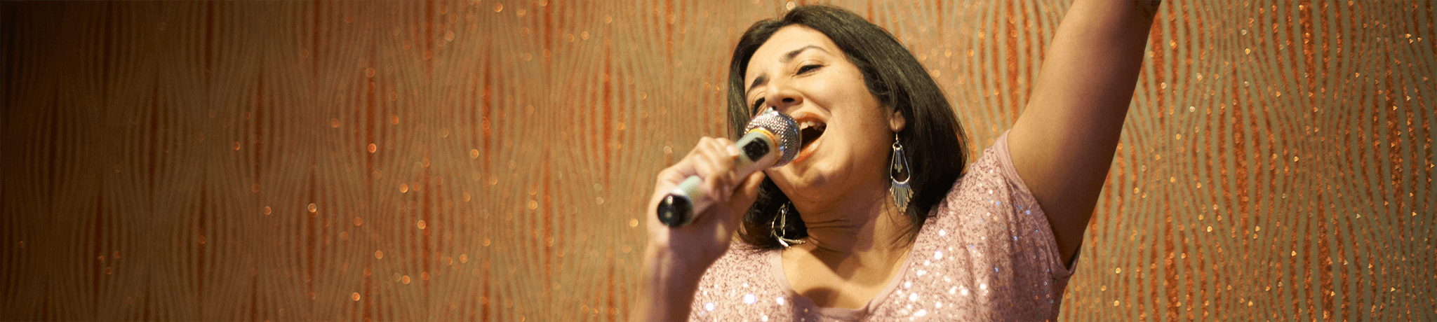 Lady singing in a spotlight