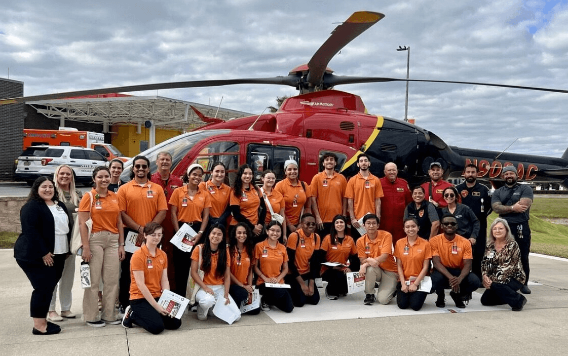 Team in front of helicopter