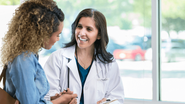 Female doctor speaks to patient