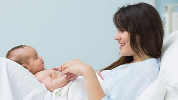 Mom holds baby on lap