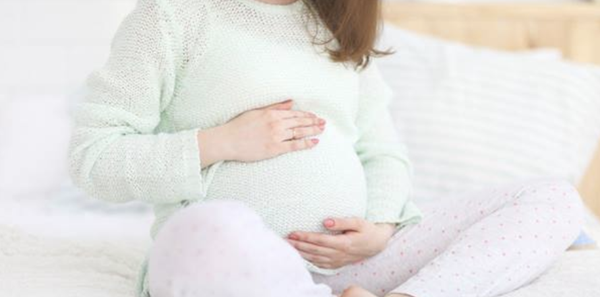 Pregnant woman holding belly