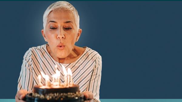Woman blowing out candles