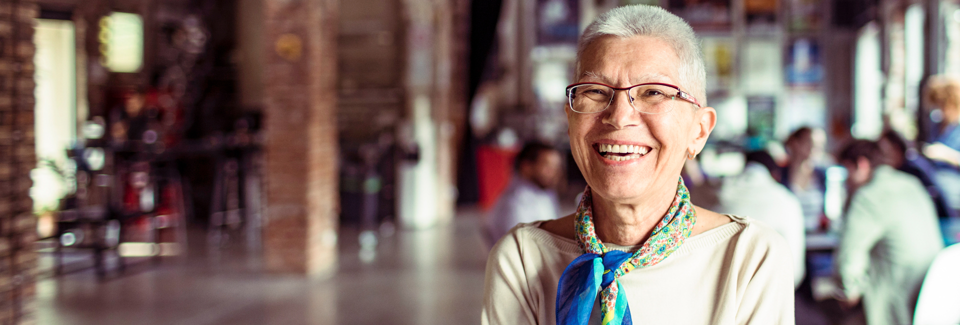 woman smiling with people in background