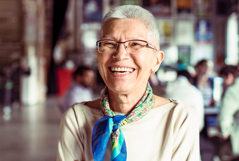 woman smiling with people in background
