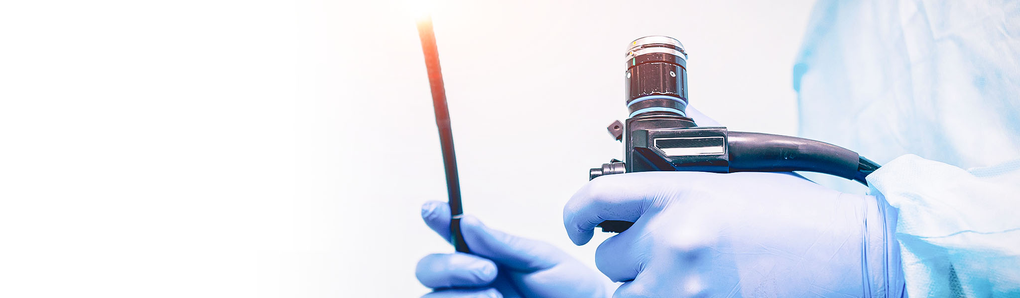 Physician hands with gloves holding medical equipment