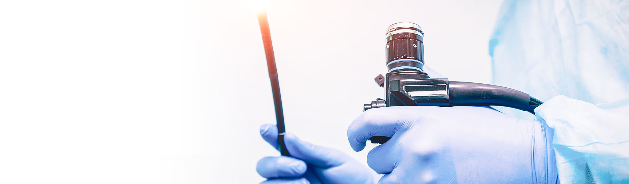 Physician hands with gloves holding medical equipment