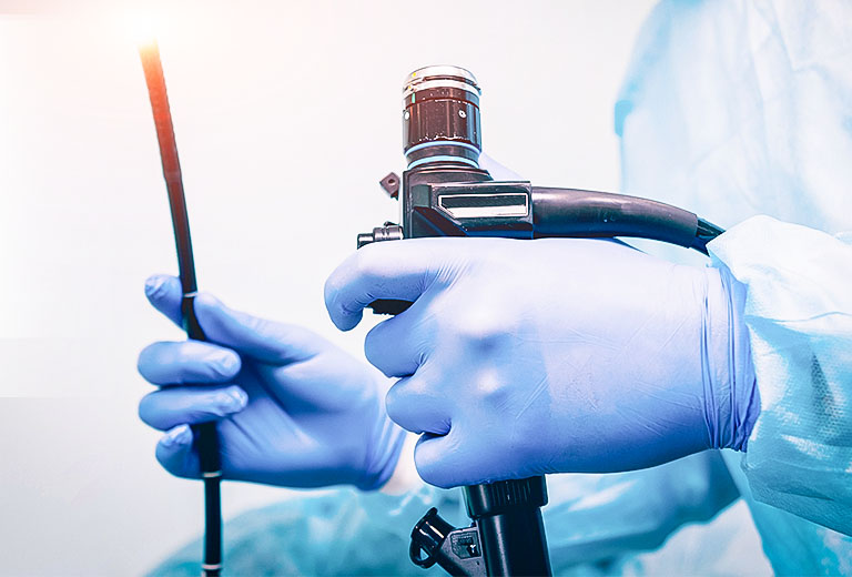 Physician hands with gloves holding medical equipment