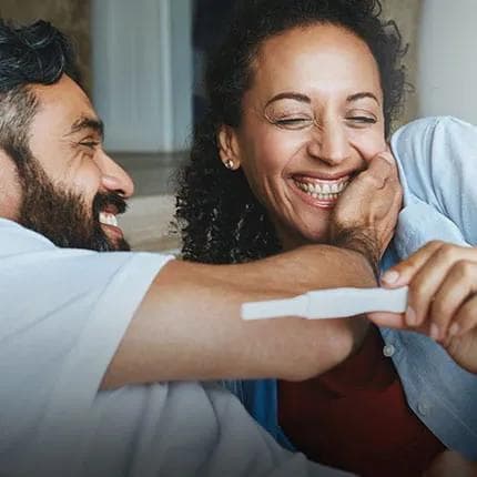Happy couple looking at pregnancy test