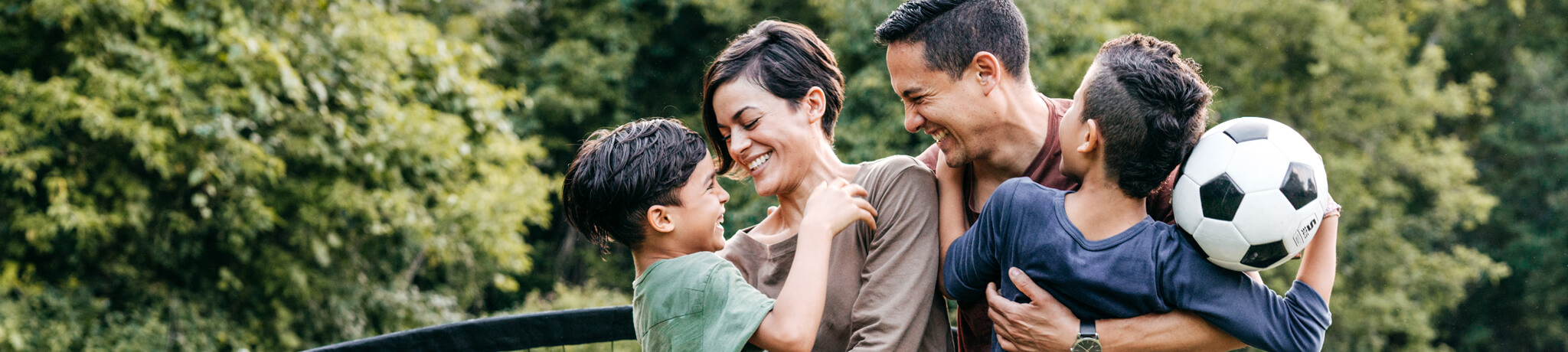 family of four with soccer ball