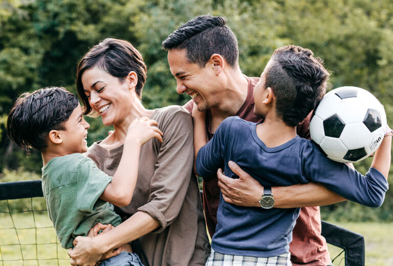 family of four with soccer ball