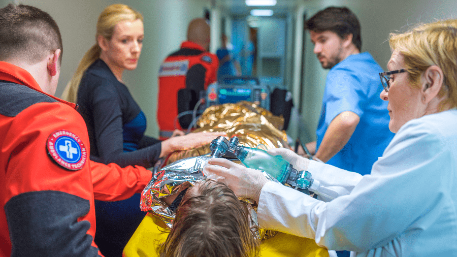 Trauma patient being transported to trauma bay.