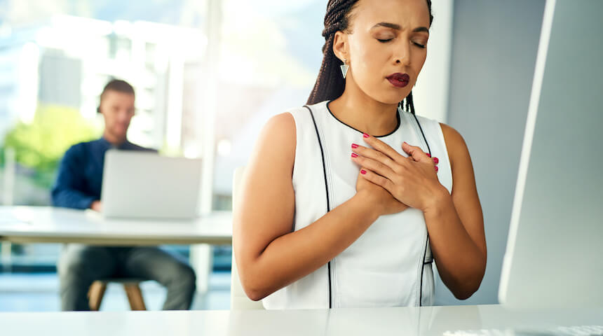 Woman holding her chest with both hands
