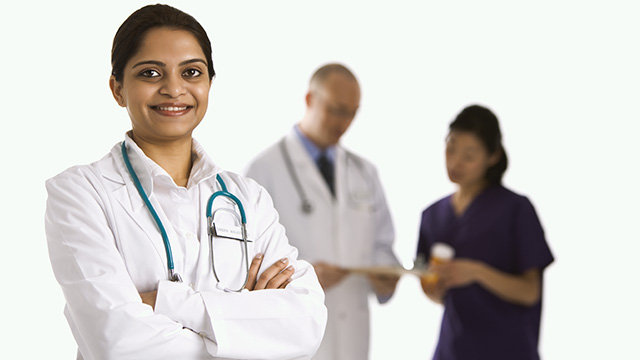 Physicians posing in front of white background