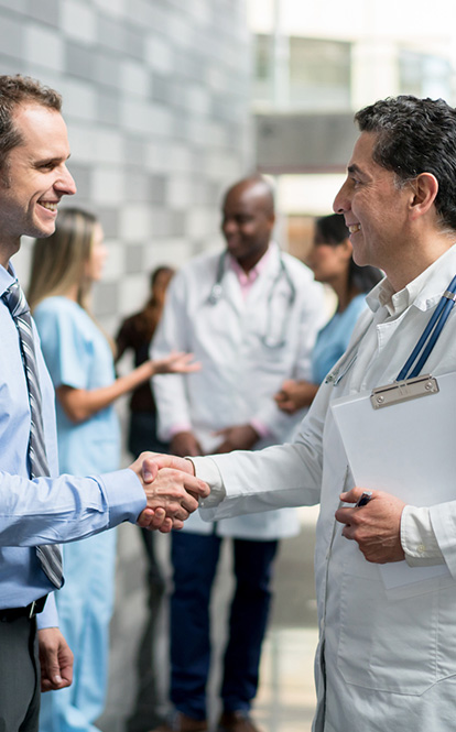 Doctor and insurance agent shaking hands