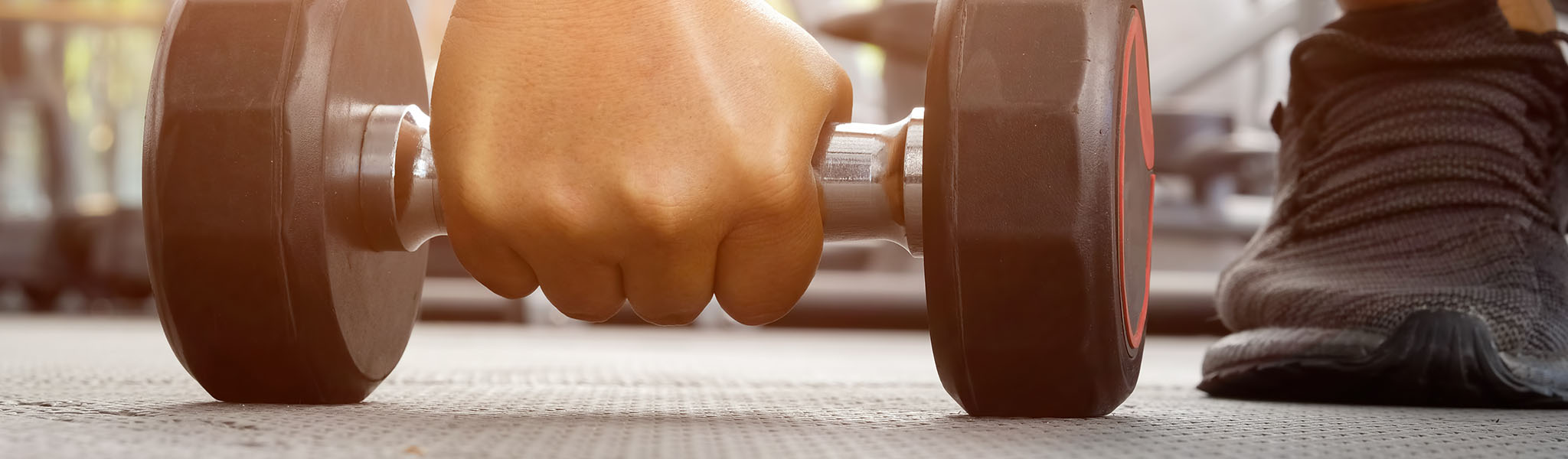 Hand grabbing dumbbell