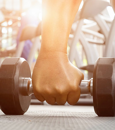 Hand grabbing dumbbell