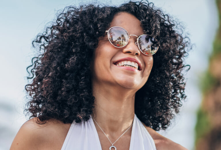 Woman with sunglasses smiling