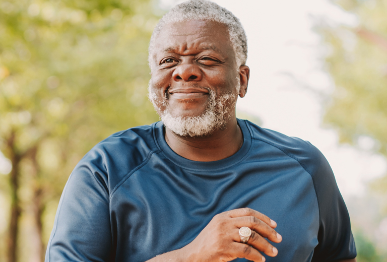 man smiling running outdoors