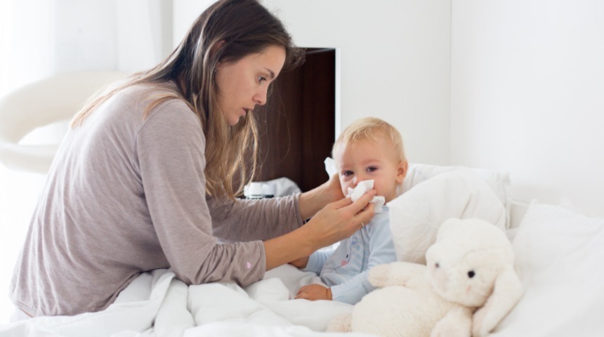 Mom wiping baby nose