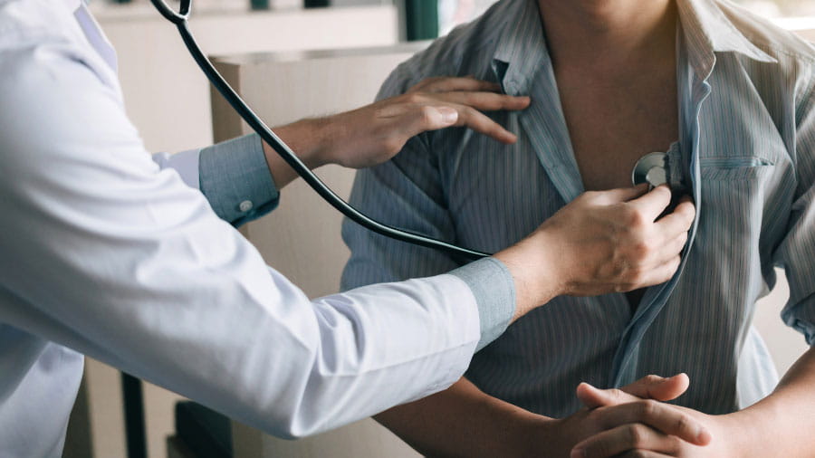 Doctor listening to patients heart