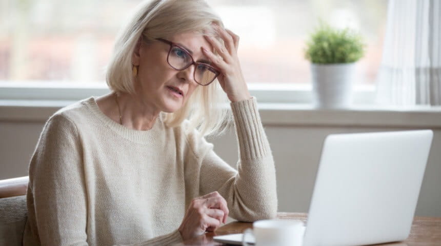 Person holding head due to brain fog