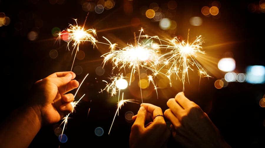 hands holding sparklers