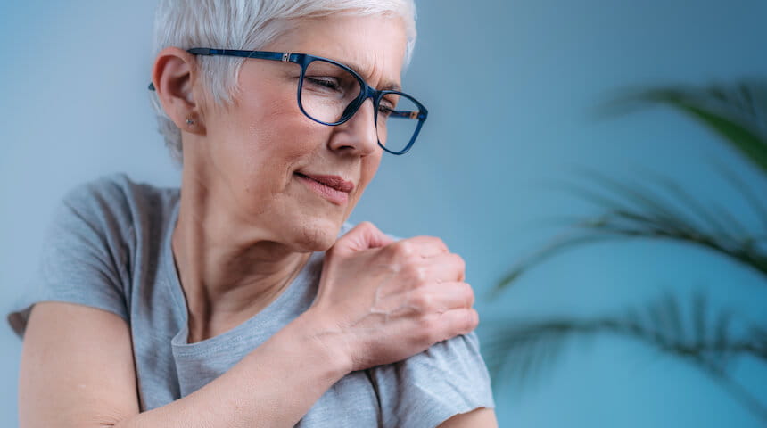 Woman with hand on shoulder