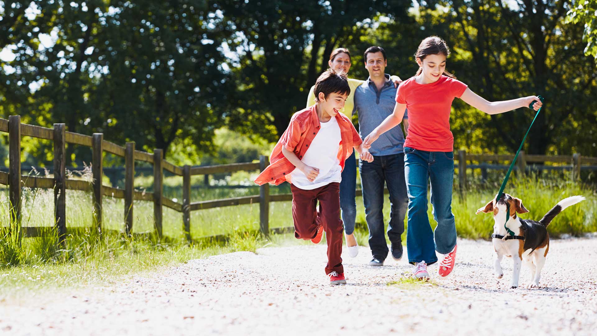 Hispanic Family Taking Dog For Walk