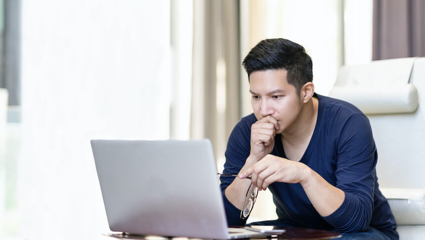 Man looking at laptop with concern