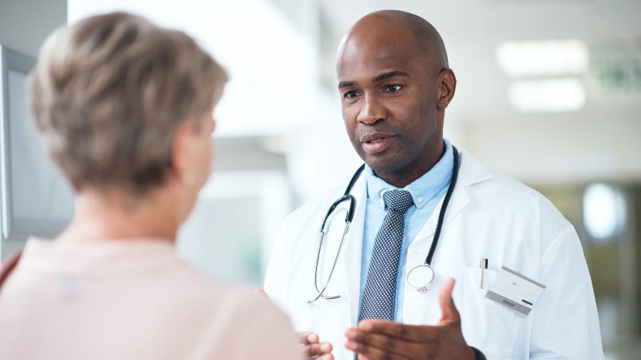 Male doctor talking with female patient