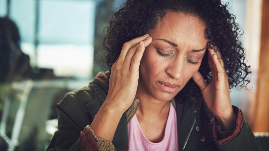 Older woman holding temples in pain