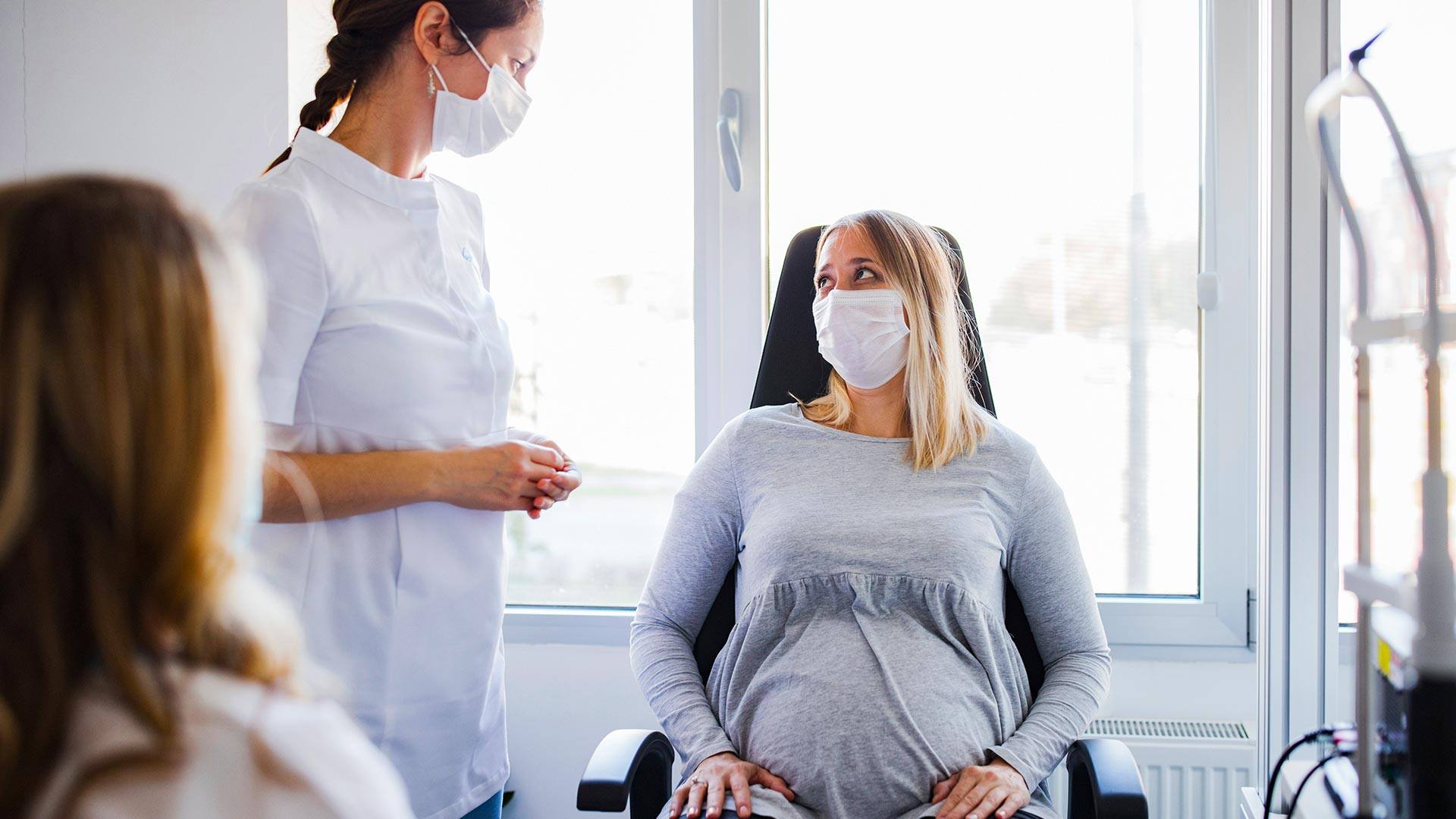 Pregnant woman talking to her doctor