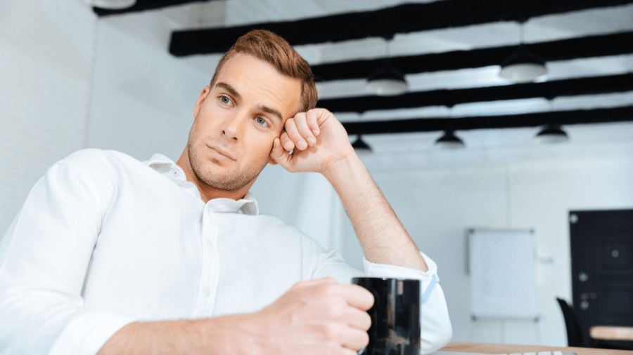 Man spaced out at desk.