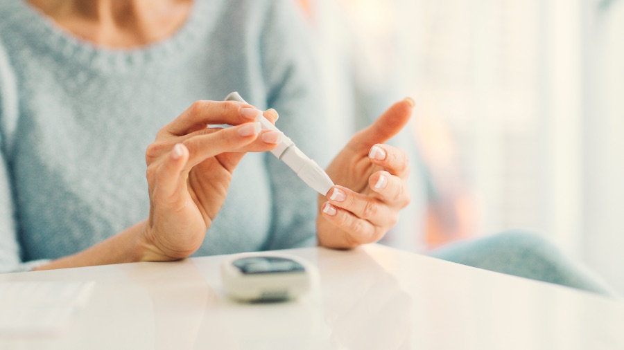 Woman pricking finger