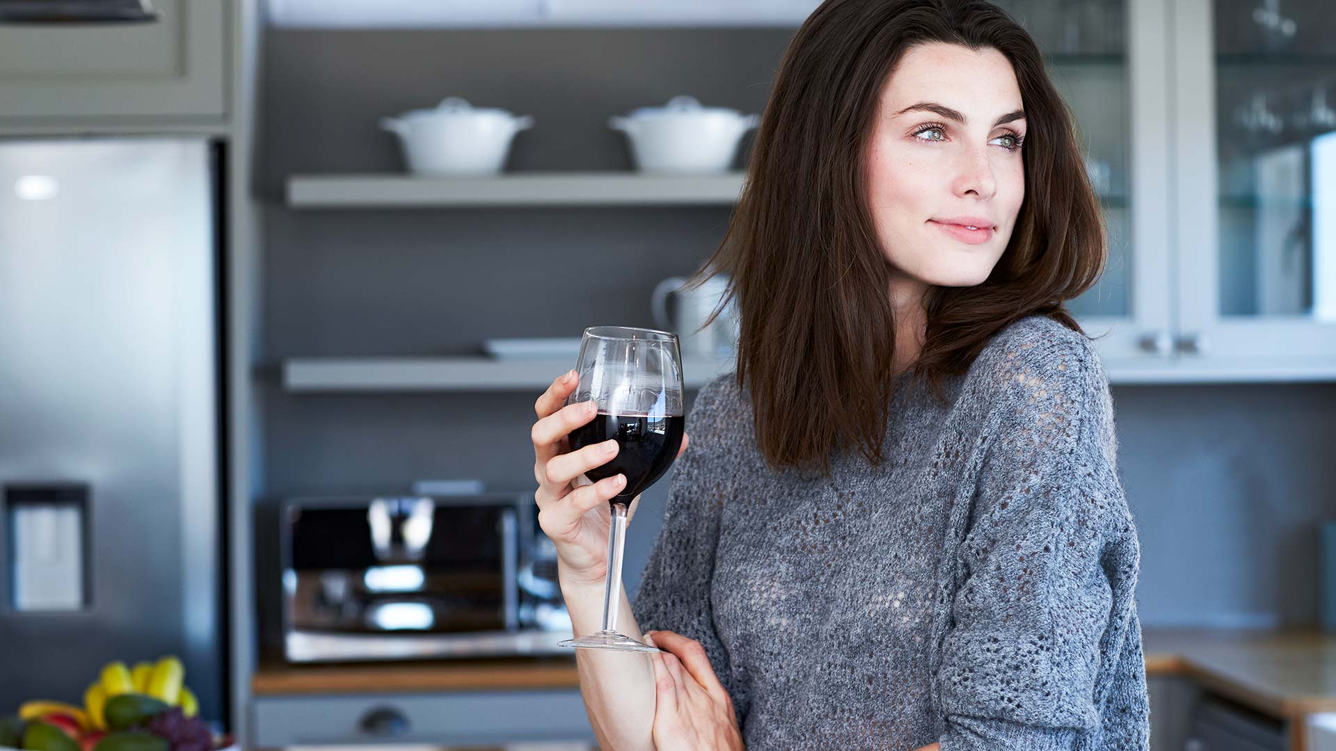 Young mom drinking a glass of wine