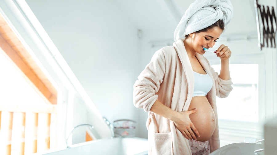 Pregnant woman brushing teeth