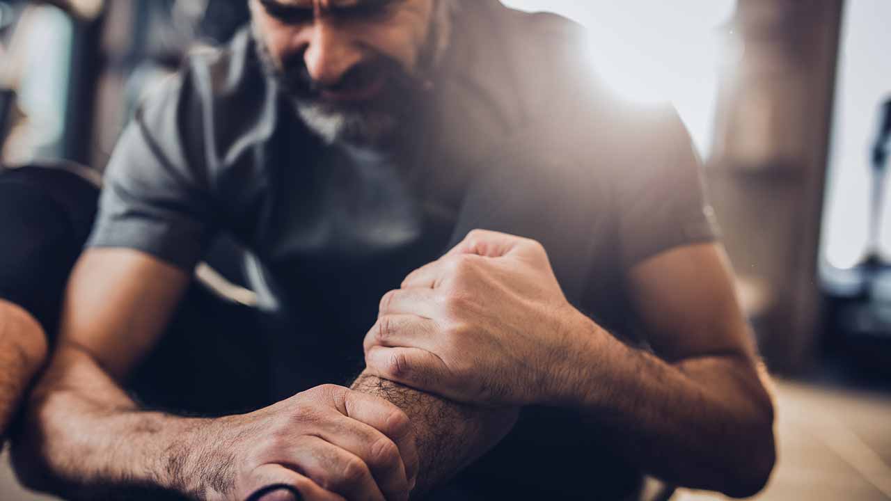 Man holding his knee in pain