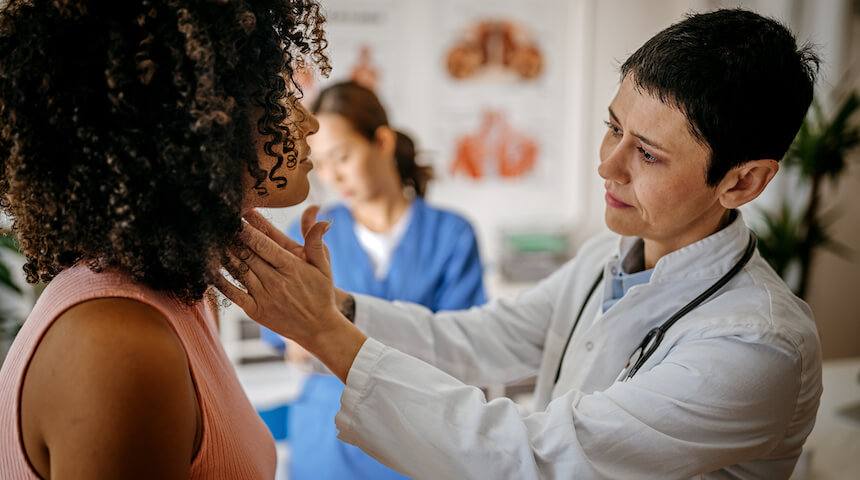 Doctor with patient checking neck