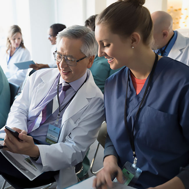 Doctor and Nurse looking at Mobile Phone