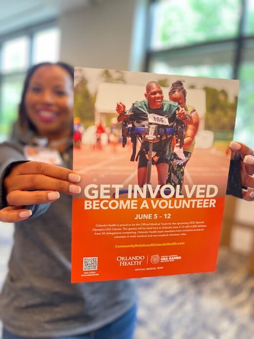 Volunteer holding poster
