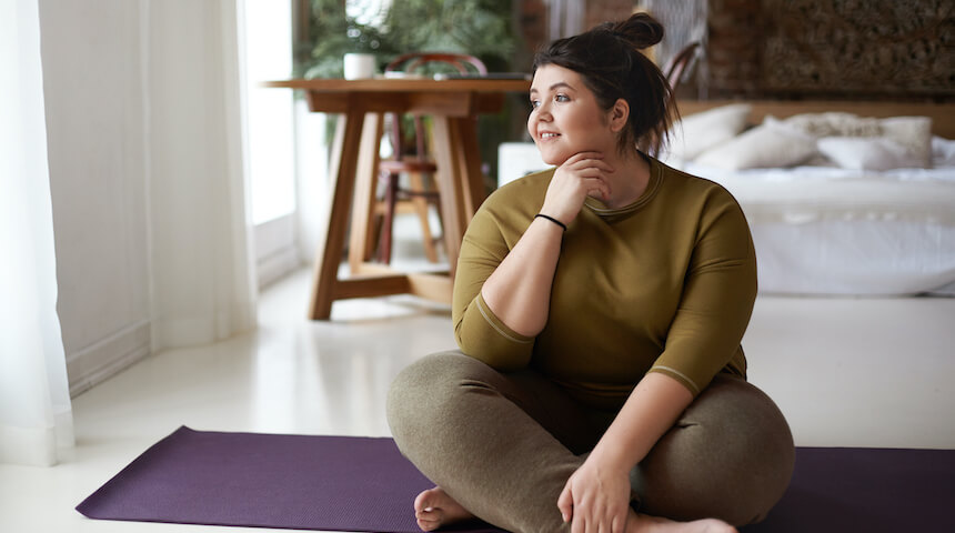 Woman sitting on yoga mat