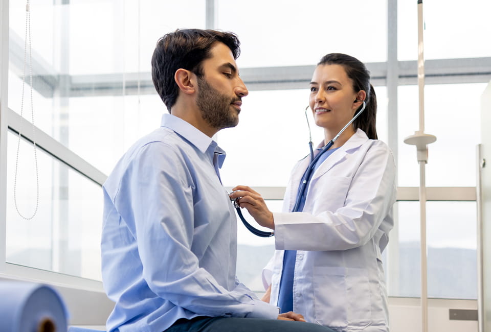 doctor using stethoscope on patient