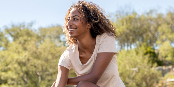 woman smiling with trees in background