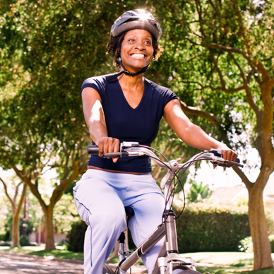 woman wearing helmet on bicycle